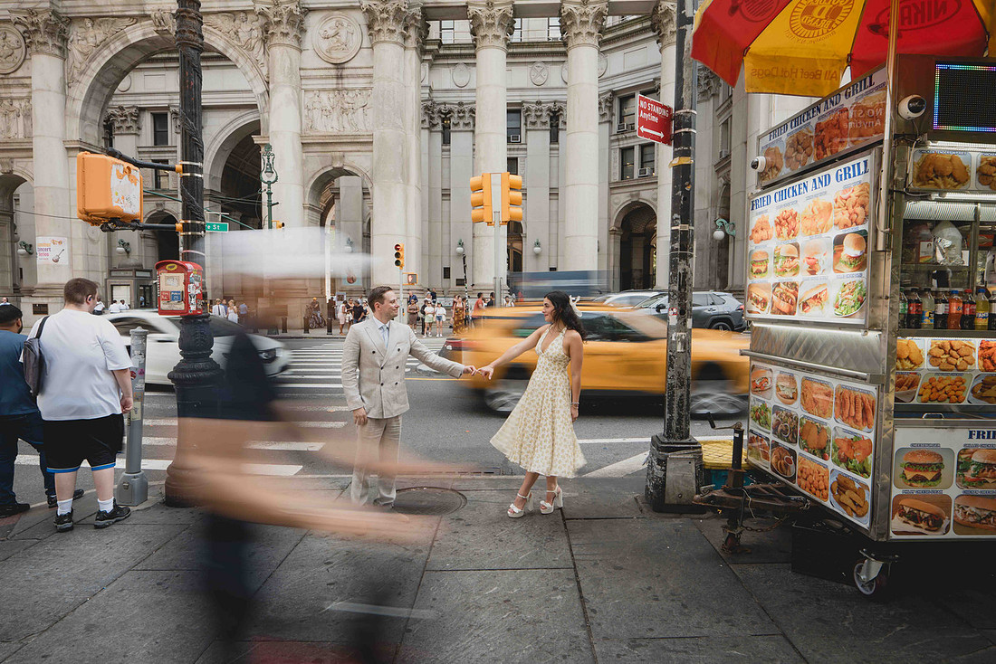 Long-exposure NYC City Hall wedding portrait on a busy Manhattan street.