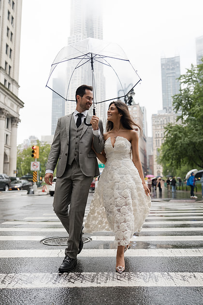 Rainy day City Hall wedding with clear umbrella, candid portrait