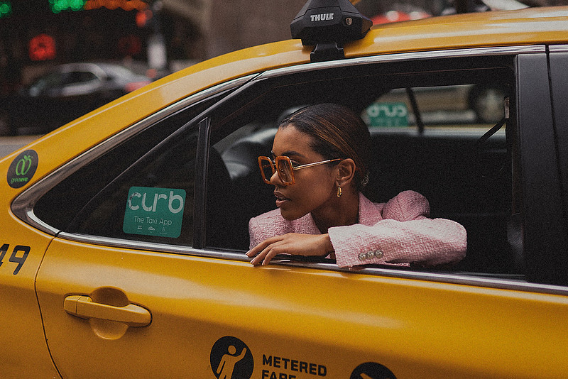 Selena Jutton pauses at the curb in Midtown, heels aligned with the crosswalk stripes.