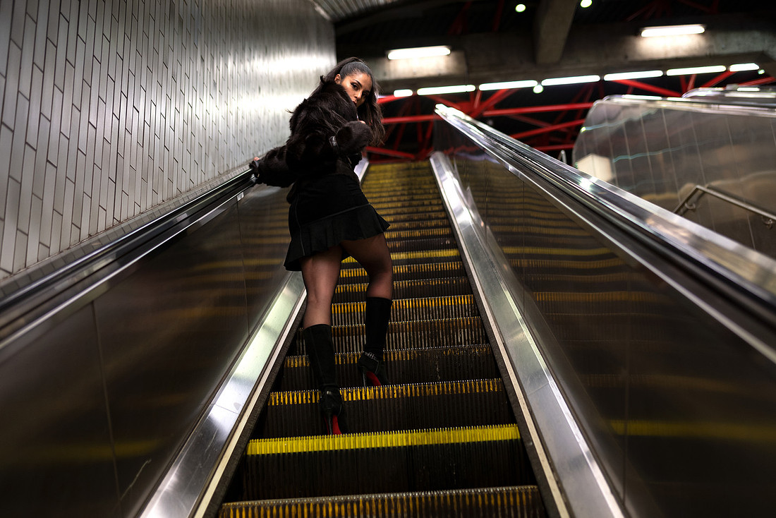 Marisol Sollyluna arrives on a NYC subway platform in a leather jacket, under fluorescent lights.