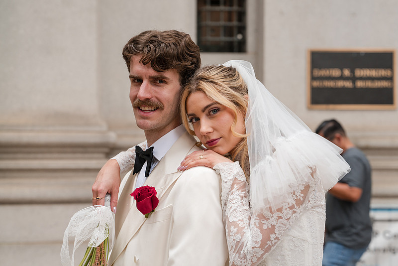 Bride hugging groom from behind near the Manhattan Municipal Building — NYC City Hall wedding portrait