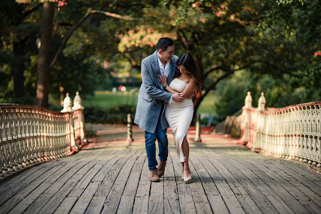 Couple walking on Bow Bridge during Central Park engagement session — NYC engagement photographer Kali Artistry